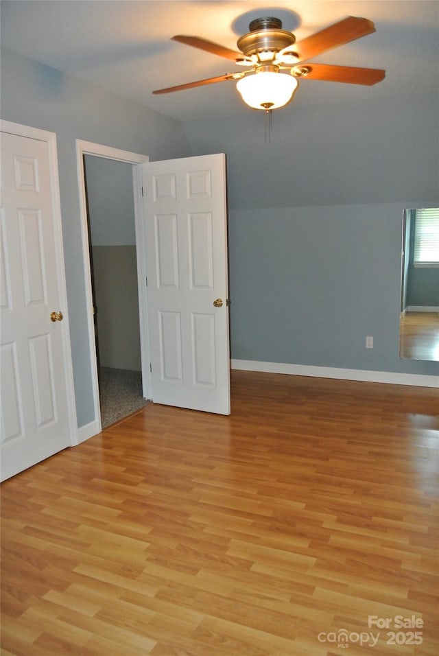177 Line Dr, Forest City, NC 28043 - unfurnished bedroom with light wood-style floors, a ceiling fan, baseboards, and vaulted ceiling