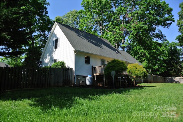 177 Line Dr, Forest City, NC 28043 - view of side of home featuring a fenced backyard, a shingled roof, and a lawn