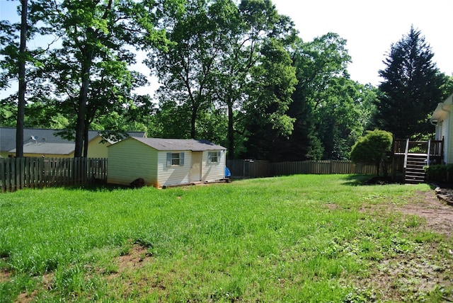 177 Line Dr, Forest City, NC 28043 - view of yard featuring an outdoor structure, a fenced backyard, stairway, and a deck