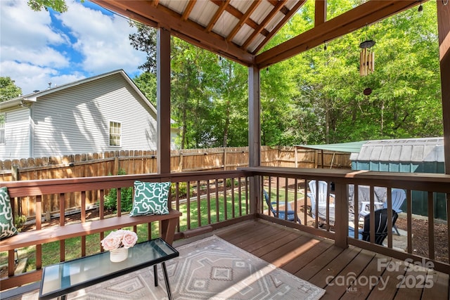 wooden deck featuring a fenced backyard