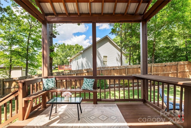 wooden deck featuring a fenced backyard
