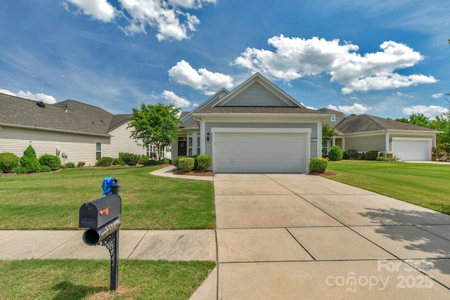 ranch-style home featuring a front lawn and concrete driveway