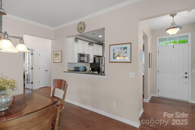 interior space with baseboards, ornamental molding, and dark wood-style floors
