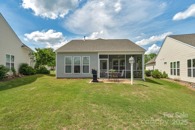 back of house featuring a yard, a patio, a sunroom, and roof with shingles