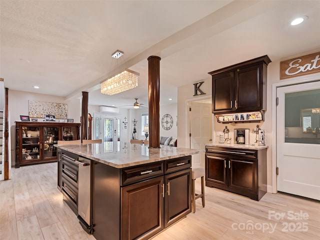 6780 Max Patch Rd, Clyde, NC 28721 - kitchen featuring light stone countertops, decorative columns, and light wood-style floors