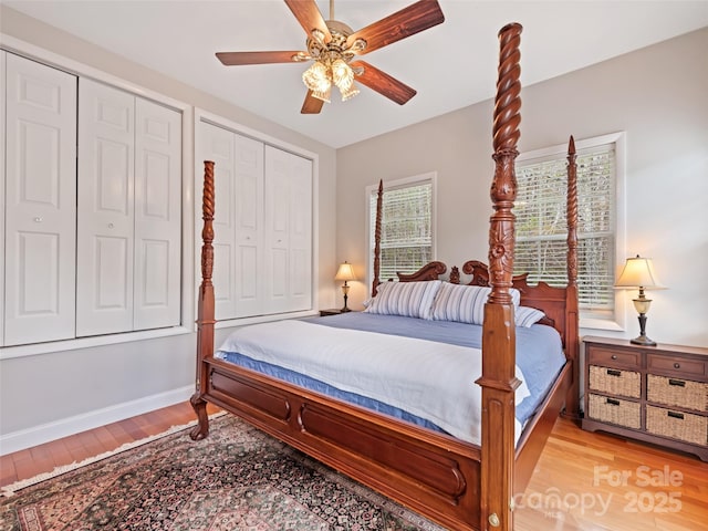 6780 Max Patch Rd, Clyde, NC 28721 - bedroom with multiple closets, ceiling fan, baseboards, and light wood-type flooring