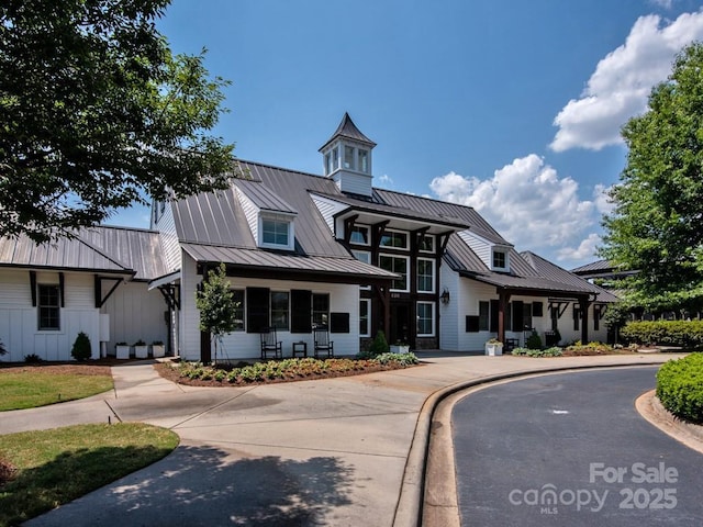 view of front of home featuring metal roof, covered porch, and a standing seam roof
