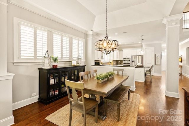 dining area featuring baseboards, dark wood-style floors, recessed lighting, ornate columns, and a chandelier