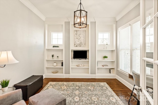 living area featuring ornamental molding, dark wood finished floors, built in shelves, and a notable chandelier