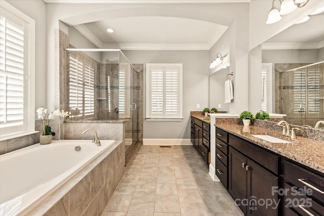 bathroom featuring crown molding, a shower stall, a bath, and vanity