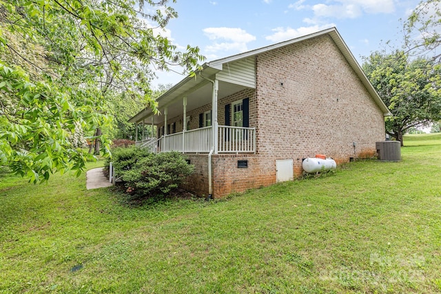 view of property exterior with brick siding, central air condition unit, a lawn, and crawl space
