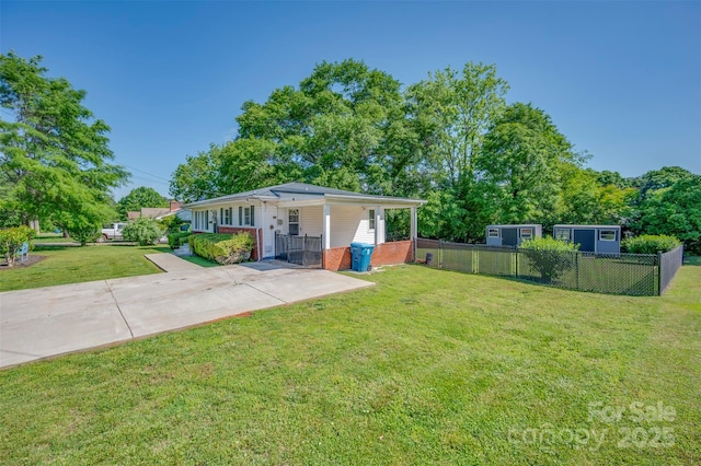 exterior space with a yard, brick siding, and fence