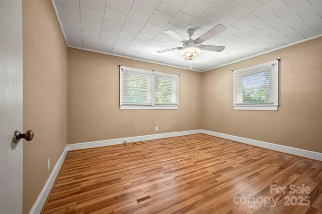 unfurnished room with crown molding, ceiling fan, a wealth of natural light, and light wood-style flooring