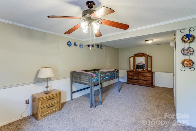 bedroom with ornamental molding, carpet flooring, and ceiling fan
