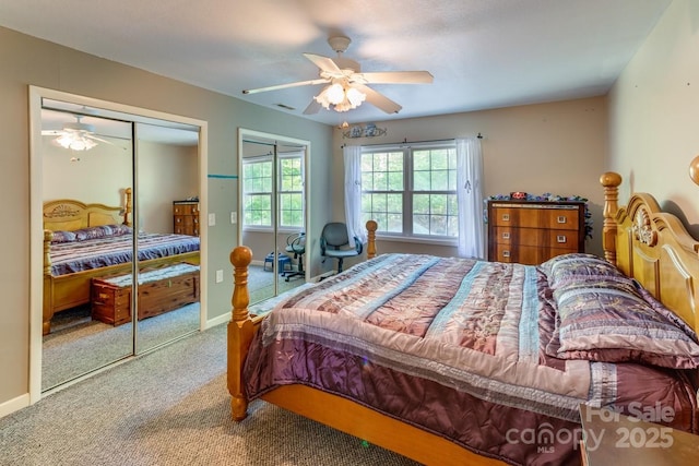 bedroom featuring carpet flooring, a ceiling fan, visible vents, and a closet