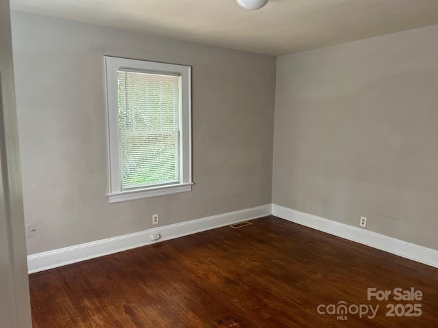 2433 Booker Ave, Charlotte, NC 28216 - empty room featuring baseboards and dark wood finished floors