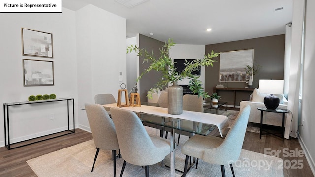 dining space featuring baseboards, recessed lighting, and wood finished floors