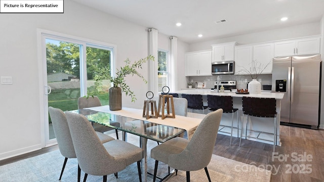 dining space with visible vents, recessed lighting, wood finished floors, and a wealth of natural light