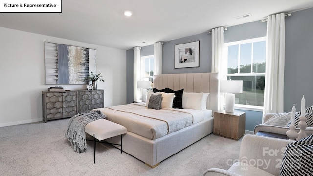 bedroom with carpet flooring, baseboards, visible vents, and multiple windows