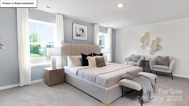 bedroom with baseboards, visible vents, and light carpet