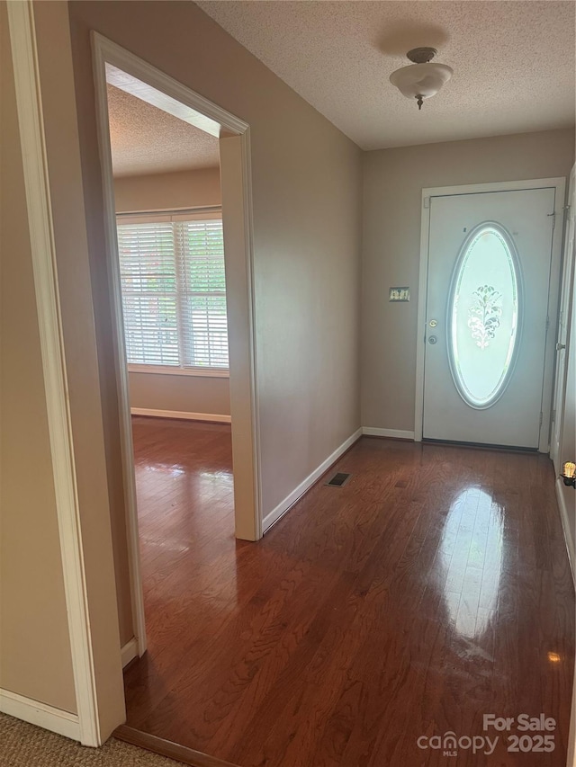 165 Graceland Pl, Salisbury, NC 28146 - entrance foyer featuring wood finished floors, a textured ceiling, and baseboards