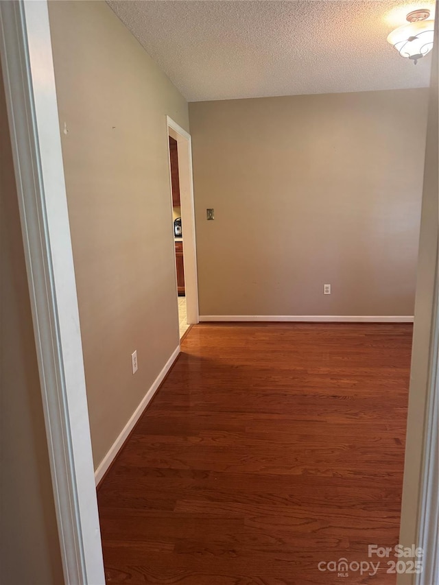 165 Graceland Pl, Salisbury, NC 28146 - empty room featuring wood finished floors, a textured ceiling, and baseboards