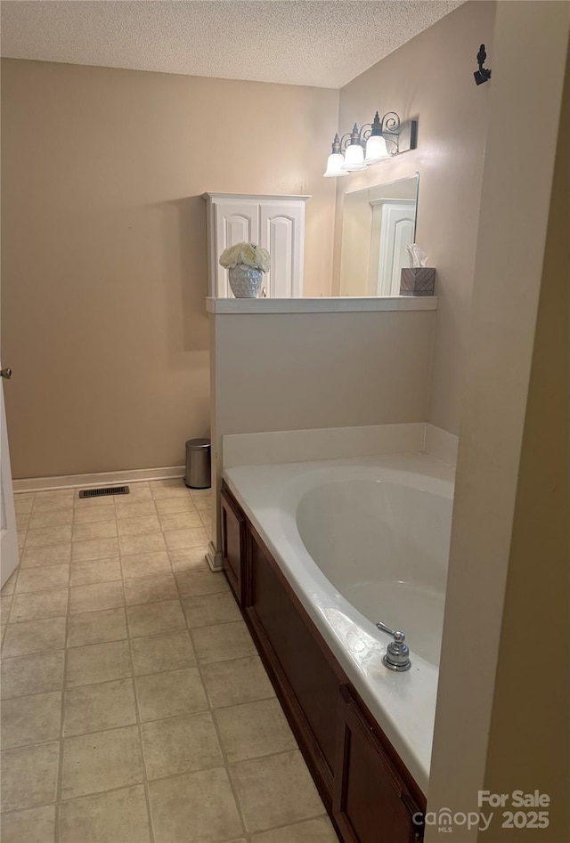 165 Graceland Pl, Salisbury, NC 28146 - bathroom with a textured ceiling, a garden tub, and tile patterned flooring
