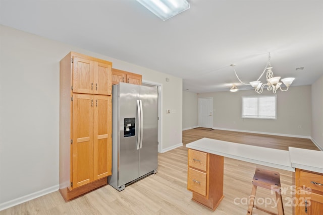 kitchen featuring light wood-style floors, baseboards, a chandelier, and stainless steel fridge with ice dispenser