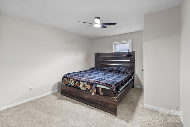 carpeted bedroom featuring baseboards and a ceiling fan