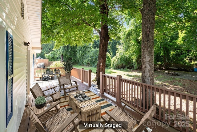 wooden terrace featuring view of scattered trees