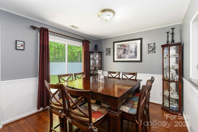 6736 Raeburn Ln, Charlotte, NC 28227 - dining area with ornamental molding, dark wood finished floors, and visible vents