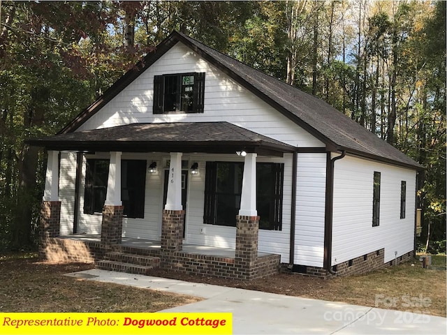 bungalow-style home featuring a porch, crawl space, and roof with shingles