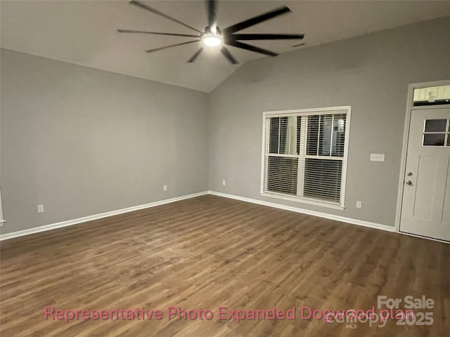 spare room with dark wood-type flooring, baseboards, ceiling fan, and vaulted ceiling