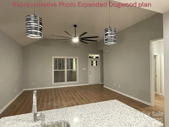 unfurnished living room featuring ceiling fan, a sink, baseboards, wood finished floors, and vaulted ceiling