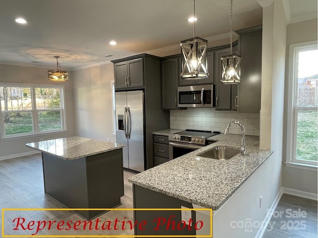 kitchen with backsplash, stainless steel appliances, baseboards, and a sink