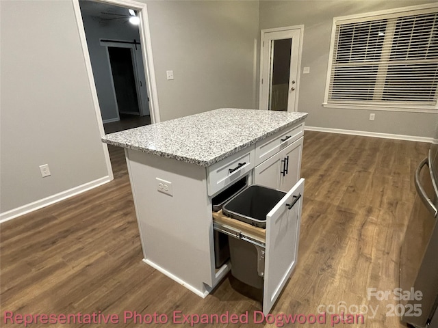 kitchen featuring dark wood-type flooring, baseboards, and white cabinets