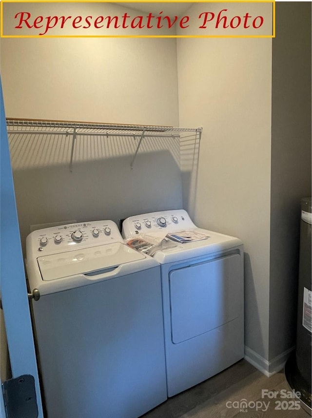 laundry room featuring separate washer and dryer, laundry area, baseboards, and water heater