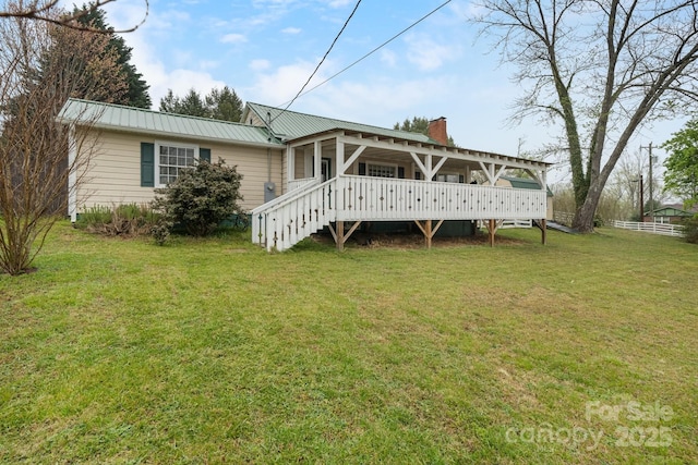 591 E Oak St, Marion, NC 28752 - rear view of property featuring a yard, a wooden deck, metal roof, and a chimney