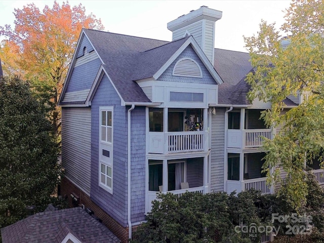 525 N Graham St Unit 3F, Charlotte, NC 28202 - back of house with a shingled roof and a chimney