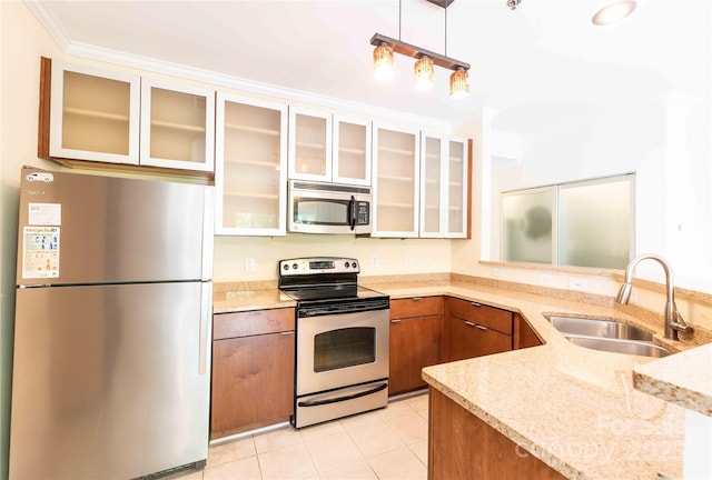 525 N Graham St Unit 3F, Charlotte, NC 28202 - kitchen featuring appliances with stainless steel finishes, light stone countertops, brown cabinets, a sink, and ornamental molding