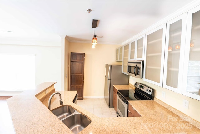 525 N Graham St Unit 3F, Charlotte, NC 28202 - kitchen with crown molding, hanging light fixtures, appliances with stainless steel finishes, a sink, and light stone counters