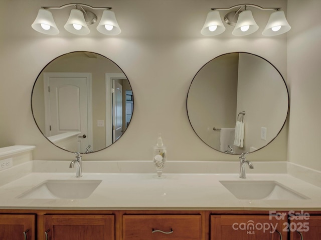 full bathroom featuring a sink and double vanity