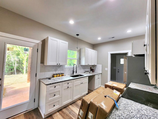 1247 Beltline Rd Unit 1, Chester, SC 29706 - kitchen featuring white cabinets, decorative backsplash, electric stove, light wood-type flooring, and light stone countertops