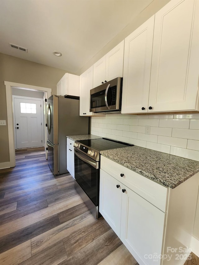 1247 Beltline Rd Unit 1, Chester, SC 29706 - kitchen featuring stainless steel appliances, dark wood-style flooring, white cabinets, stone countertops, and decorative backsplash