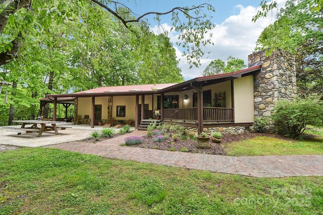 675 Terrys Gap Rd, Hendersonville, NC 28792 - view of front of house with a chimney, a front yard, and covered porch
