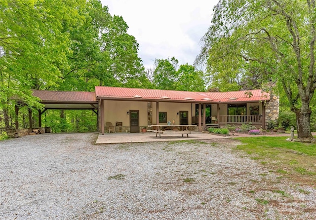 675 Terrys Gap Rd, Hendersonville, NC 28792 - view of front of property with metal roof, an attached carport, and gravel driveway