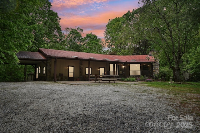 675 Terrys Gap Rd, Hendersonville, NC 28792 - view of front of house with metal roof, a chimney, and stone siding