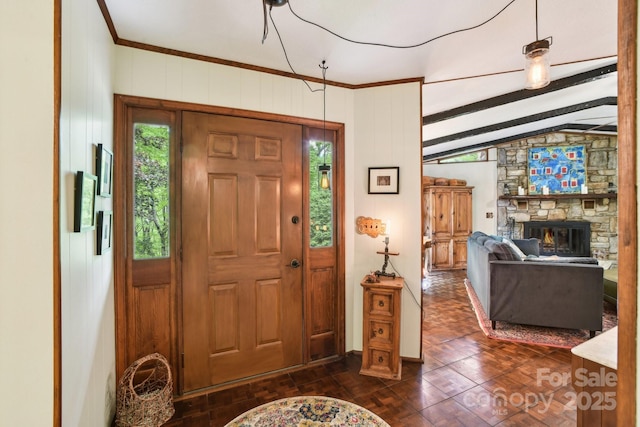 675 Terrys Gap Rd, Hendersonville, NC 28792 - entrance foyer with ornamental molding, vaulted ceiling, and a stone fireplace