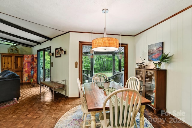 675 Terrys Gap Rd, Hendersonville, NC 28792 - dining room with ornamental molding, baseboards, a textured ceiling, and wooden walls