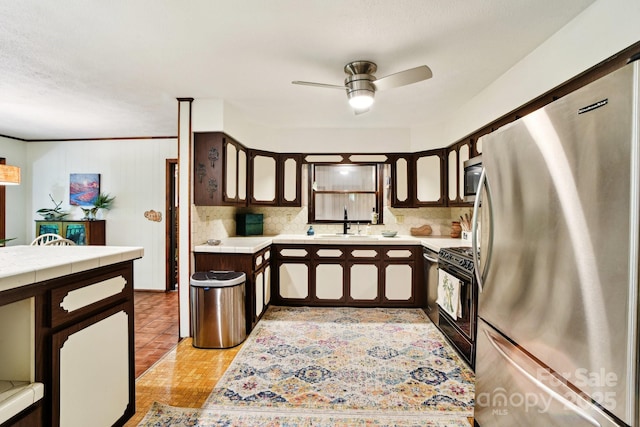 675 Terrys Gap Rd, Hendersonville, NC 28792 - kitchen featuring appliances with stainless steel finishes, tile countertops, a ceiling fan, and dark brown cabinets